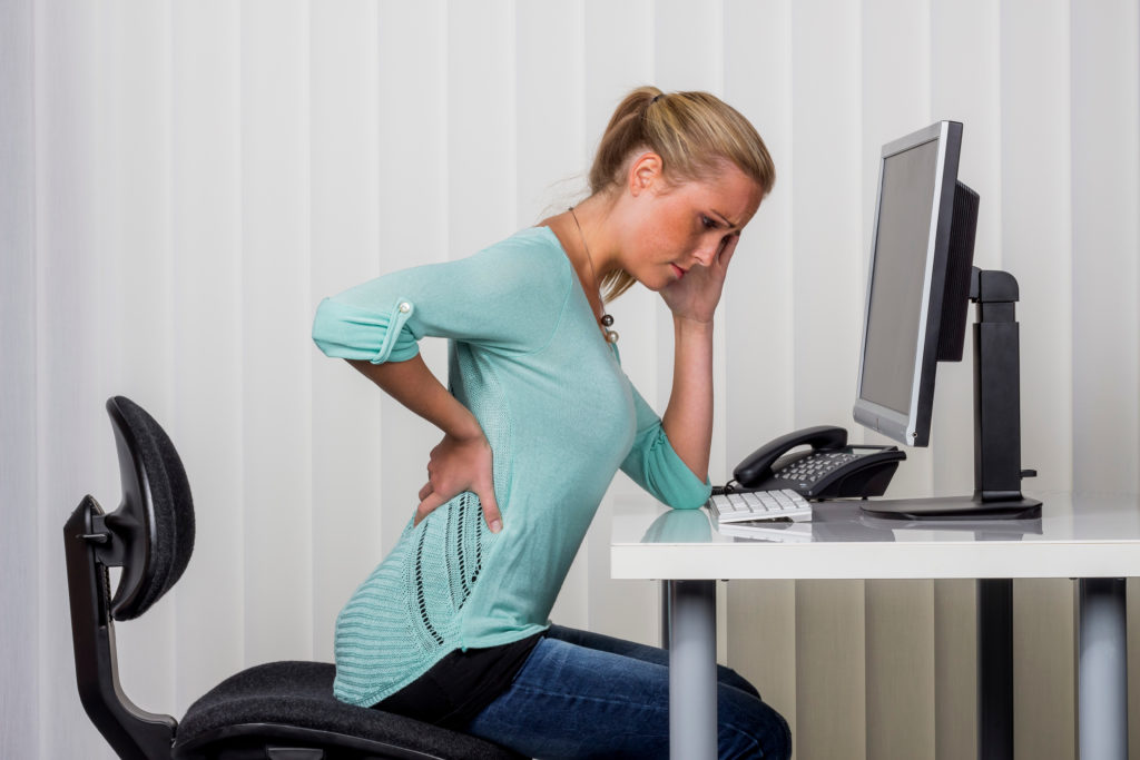 woman with backache in the office