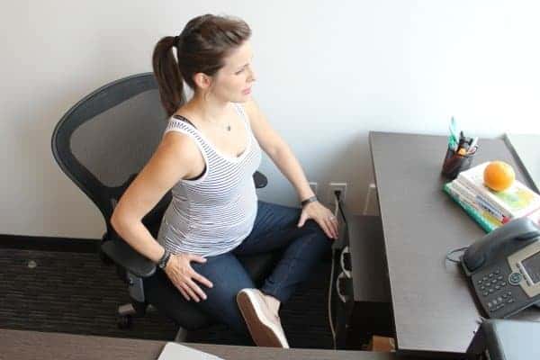 Pregnant woman sitting in office chair