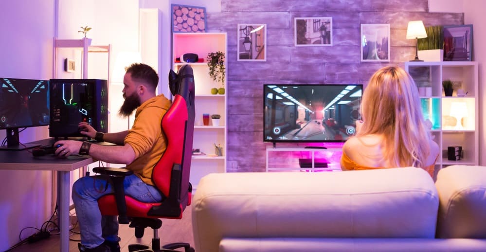 Man playing shooter games and sitting on gaming chair
