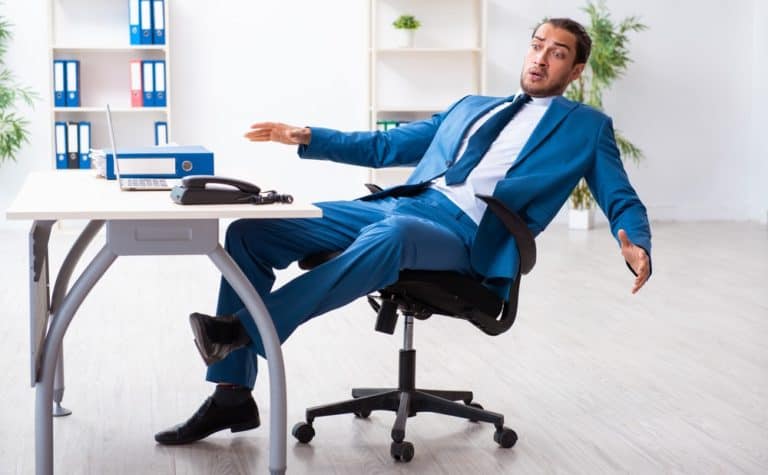 man leaning back in office chair