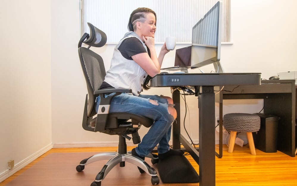 woman working from home sitting at her ergonoic home office desk