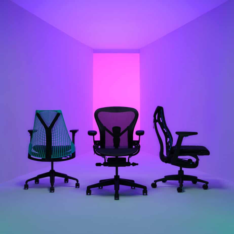 three office chairs on purple background