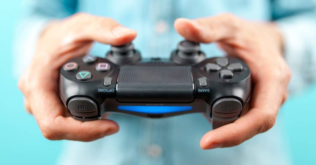 Male hands holding a PS4 controller