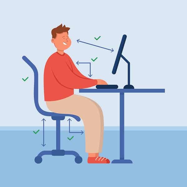 person with correct posture sitting at computer desk