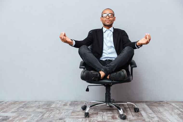 man sitting peacefully in office chair