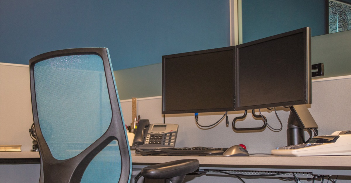 Office chair and double monitors on desk