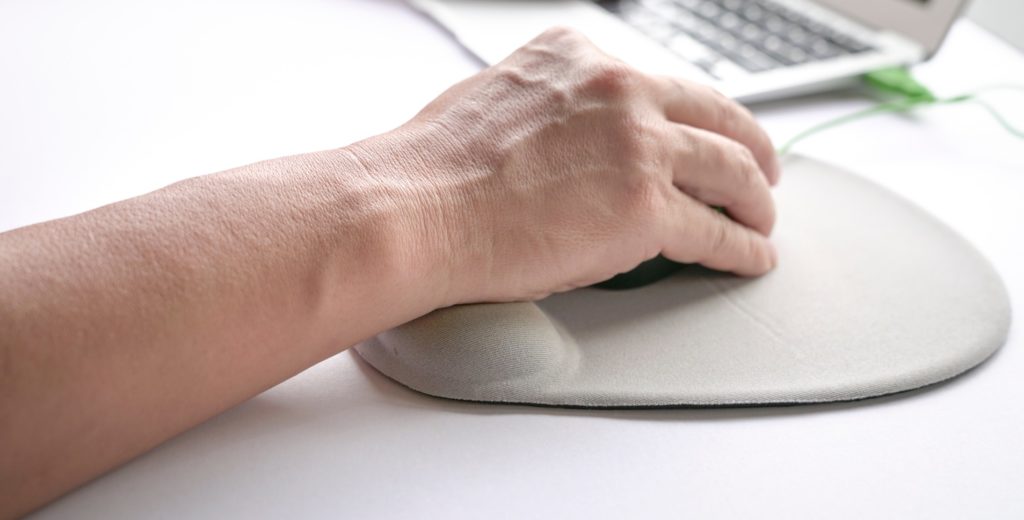 Man's fingers clicking on mouse