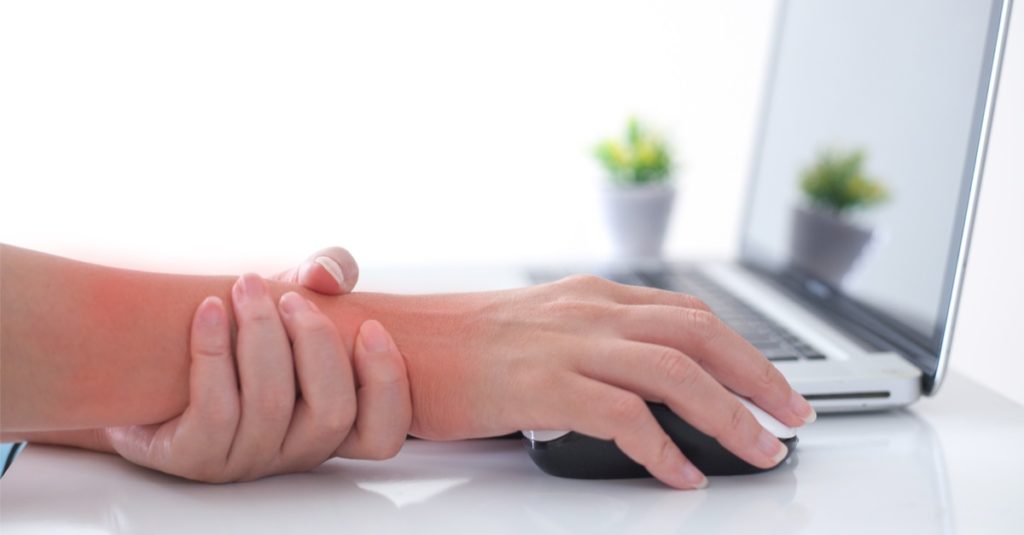 Woman-holding-her-wrist-pain-from-using-computer