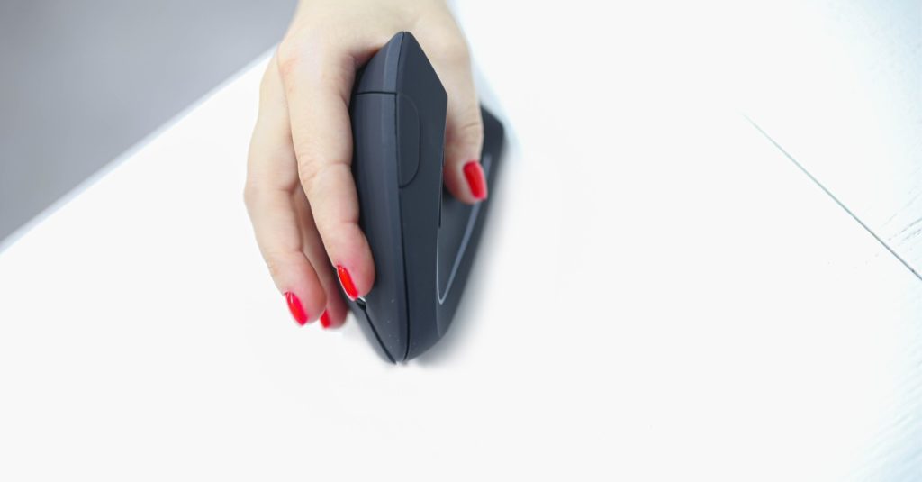 girl's hand uses a vertical ergonomic computer mouse joystick