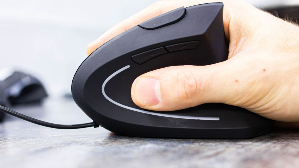 man’s hand uses a vertical ergonomic computer mouse-joystick